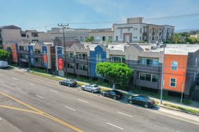 Los Angeles apartment for rent - an aerial view of a city street with cars parked in front of buildings