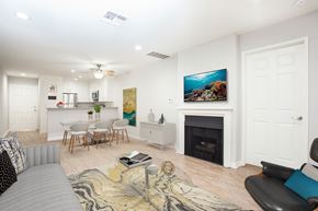 Los Angeles apartment for rent - a living room with a fireplace and a table with chairs