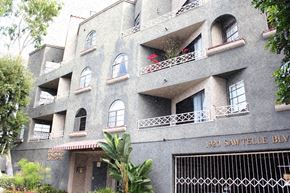 Los Angeles apartment for rent - an apartment building with many windows and a fence