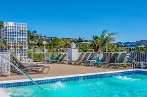 Los Angeles apartment for rent - a swimming pool with chaise lounge chairs at a resort with mountains in the background