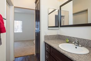Los Angeles apartment for rent - a bathroom with a sink and a mirror and a hallway to a bedroom