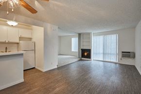West Hollywood apartment for rent - an empty living room with a fireplace and a kitchen