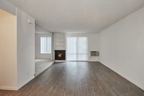 West Hollywood apartment for rent - an empty living room with a fireplace and wood flooring