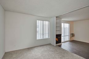West Hollywood apartment for rent - the living room and dining room of an apartment with a fireplace