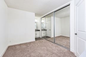 West Hollywood apartment for rent - an empty bedroom with mirrored closet doors and carpeting