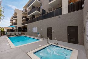 West Hollywood apartment for rent - A small pool with a hot tub in front of a building.