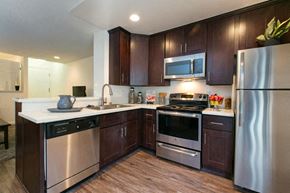 West Hollywood apartment for rent - a kitchen with stainless steel appliances and wooden cabinets