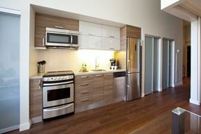 Toronto apartment for rent - A modern kitchen with stainless steel appliances and wooden cabinets.