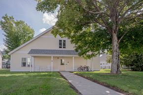 Groveton apartment for rent - a white house with a tree and a sidewalk in front of it