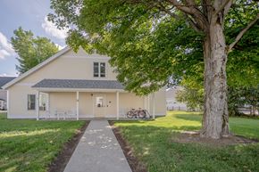 Groveton apartment for rent - a white house with a tree and a sidewalk in front of it