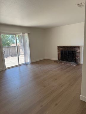 Vallejo house for rent - A room with a fireplace and sliding glass doors.