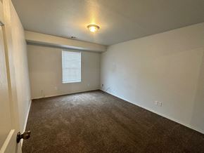 Pea Ridge apartment for rent - A room with a carpeted floor and a window with blinds.