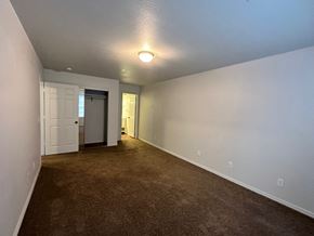 Pea Ridge apartment for rent - A room with a brown carpet and white walls.