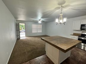 Pea Ridge apartment for rent - A kitchen with a brown countertop and white cabinets.