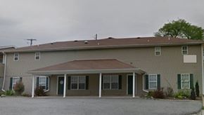 Pea Ridge apartment for rent - A house with a brown roof and a white door.