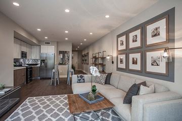 Los Angeles apartment for rent - A modern living room with a grey couch and a coffee table.