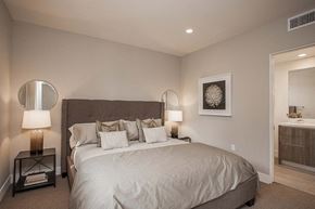 Los Angeles apartment for rent - A bedroom with a large bed and a lamp on the side table.