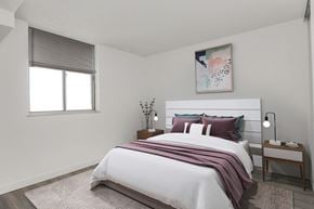 North York apartment for rent - A bedroom with a large bed and a painting above it.