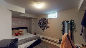 Ottawa apartment for rent - a bedroom with a bed and a dresser