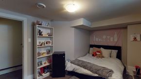 Ottawa apartment for rent - a bedroom with a bed and a book shelf