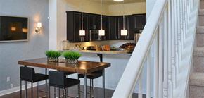 Collingswood apartment for rent - a kitchen with black cabinets and a table and chairs