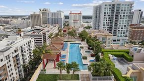 West Palm Beach apartment for rent - A view of a pool area with a red roof and a blue pool.