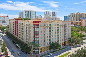 West Palm Beach apartment for rent - A large hotel with a red awning is in the middle of a street.