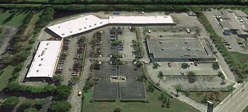 Delray Beach apartment for rent - An aerial view of a parking lot and buildings.