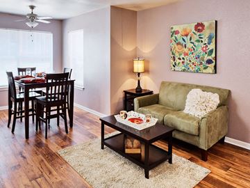 Denton apartment for rent - a living room and dining room with a couch and a table