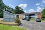Meridian apartment for rent - Monument sign next to parking lot and building at Landmark Apartment Homes, Meridian, MS
