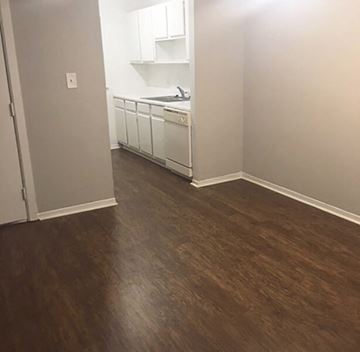 Meridian apartment for rent - an empty living room with wood floors and a kitchen