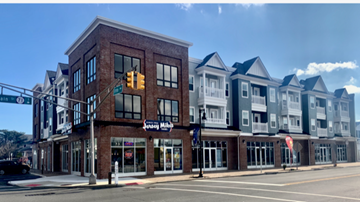 Belmar apartment for rent - a rendering of a building on the corner of a city street