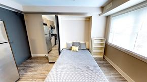 Ottawa apartment for rent - a kitchen with a large window and a rug in the middle