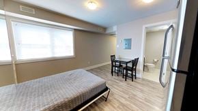 Ottawa apartment for rent - a bedroom with a bed and a bathroom with a sink