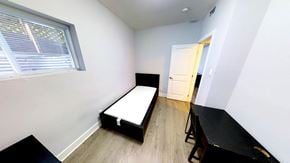 Ottawa apartment for rent - an empty room with a bed and a table