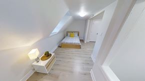 Ottawa apartment for rent - a bedroom with a bed in the middle of a white room
