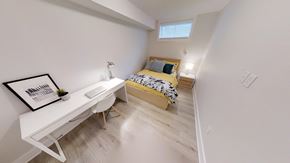 Ottawa apartment for rent - a bedroom with a desk and a bed in a room
