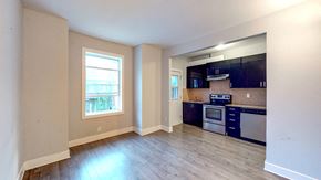 Ottawa apartment for rent - an empty kitchen with wood floors and a window