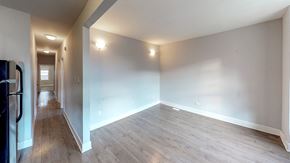 Ottawa apartment for rent - an empty living room with wood floors and white walls
