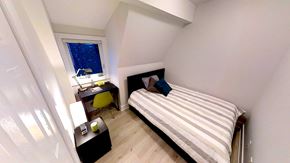 Ottawa apartment for rent - a small bedroom with a bed and a desk