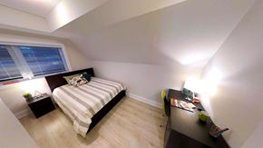 Ottawa apartment for rent - a bedroom with a bed and a desk and a window