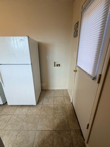Hilliard apartment for rent - A white refrigerator in a kitchen with a tiled floor.