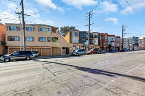 San Francisco apartment for rent - a city street with cars parked in front of buildings