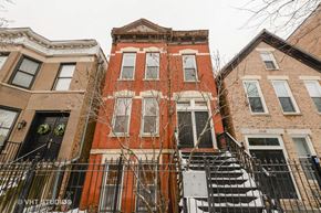Chicago apartment for rent - a red brick building with scaffolding in front of it