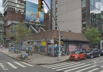 New York apartment for rent - a brick building with graffiti on the side of a city street