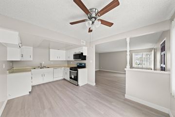Anaheim apartment for rent - an open kitchen and living room with a ceiling fan