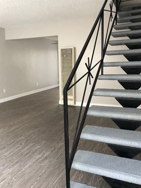 Redondo Beach apartment for rent - A staircase with a black metal railing and grey steps.