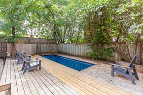 Ottawa apartment for rent - a pool in a backyard with a deck and chairs
