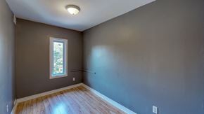 Ottawa apartment for rent - an empty room with gray walls and a window