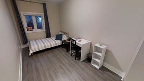 Ottawa apartment for rent - a small room with a desk and a bed